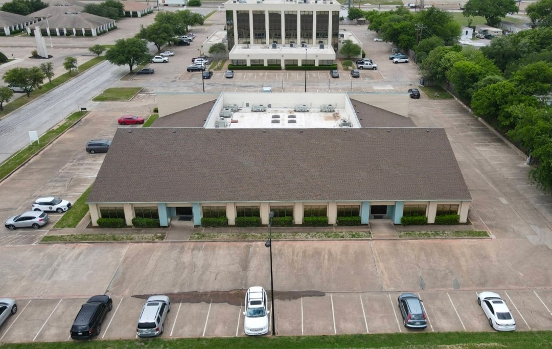 Aerial view of 6825 Manhattan Blvd showing building entrances and parking
